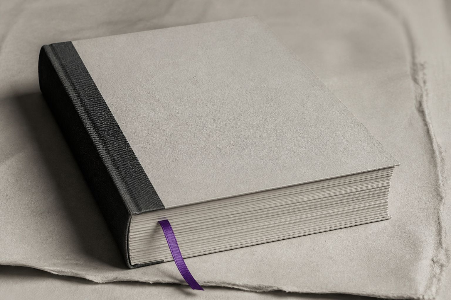 Cream booklet with charcoal spine and a violet ribbon bookmark