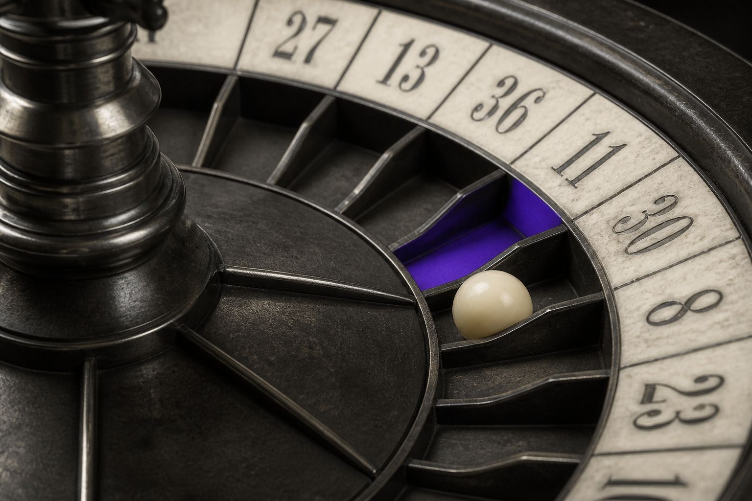 Close-up of a roulette wheel with a single violet pocket on a charcoal turret